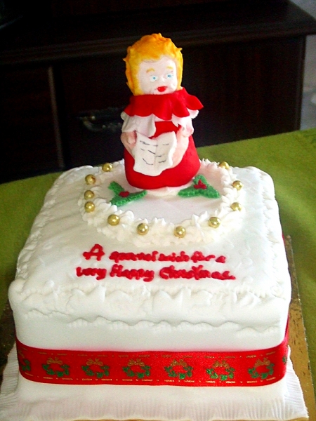 Music embossed on top of cake with handmade choirboy